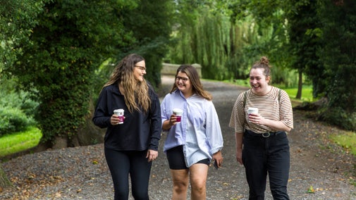 Visitors walking in the Pleasure gardens at Attingham Park, Shropshire